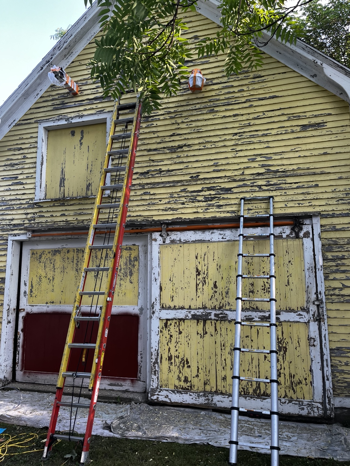 Weathered yellow wood barn before restoration