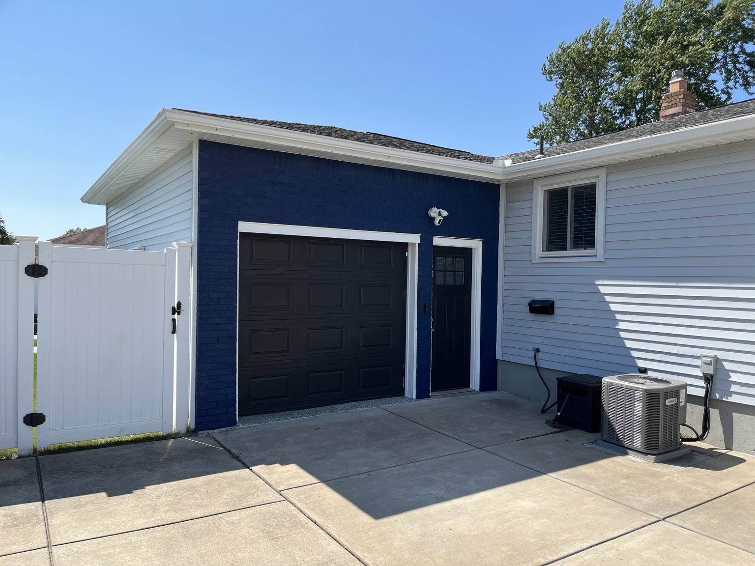 Finished navy garage exterior with black doors and white trim